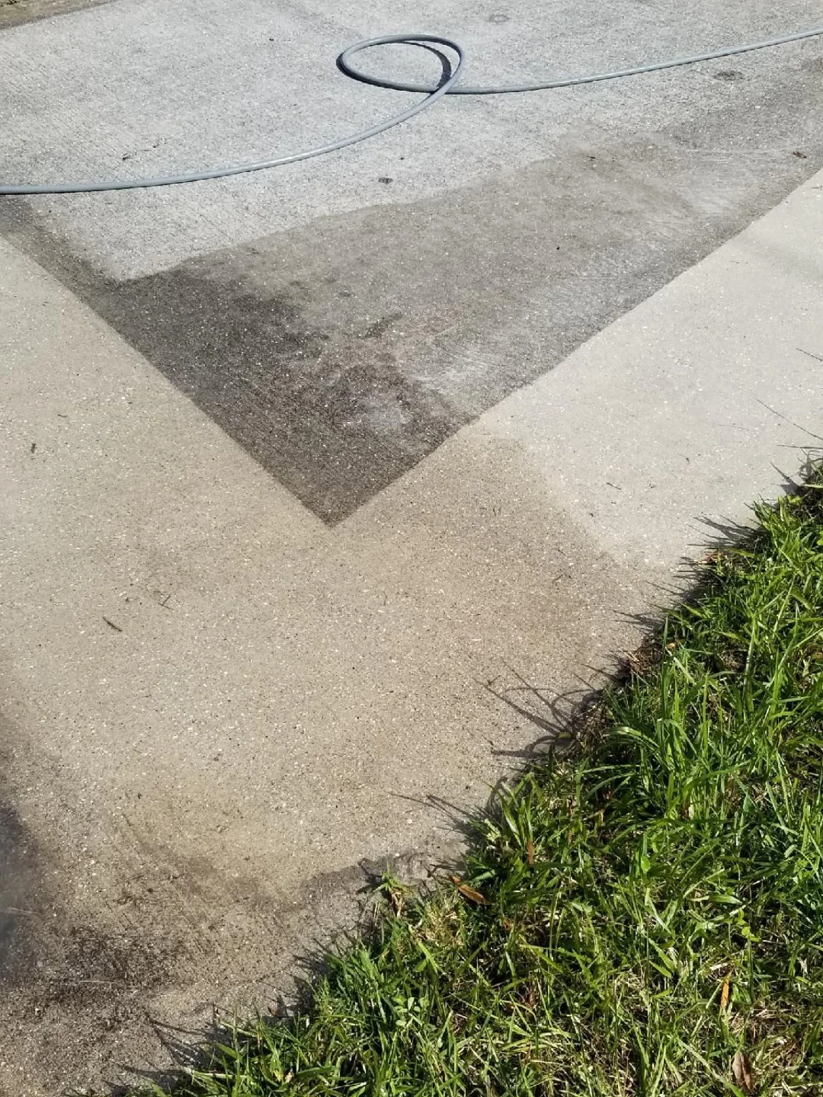 Concrete pressure washing in progress